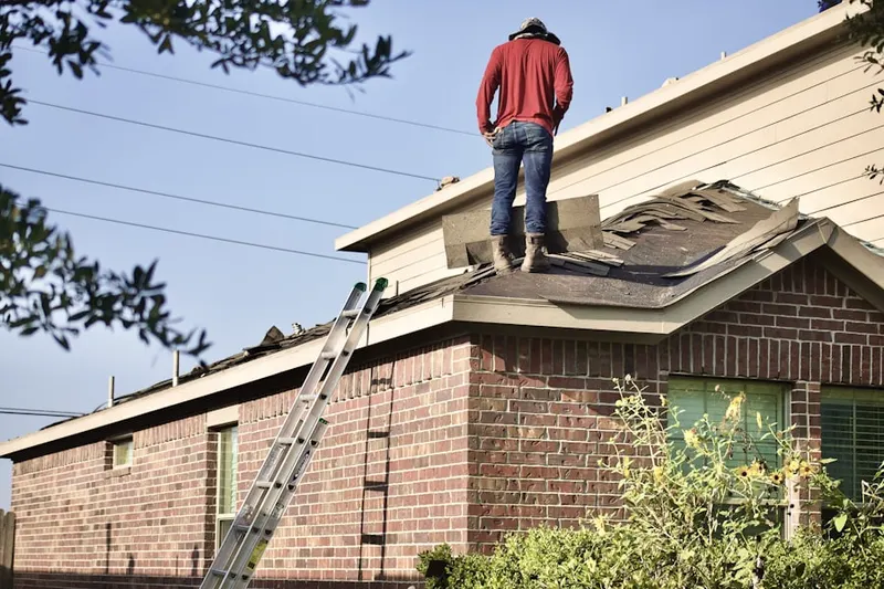 Professional roofer working on a residential roof in Orange City